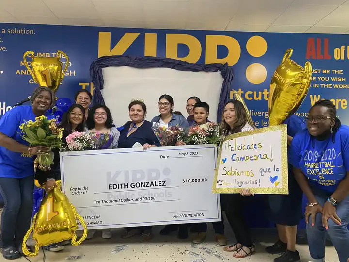 KIPP teachers awarded money, holding giant check