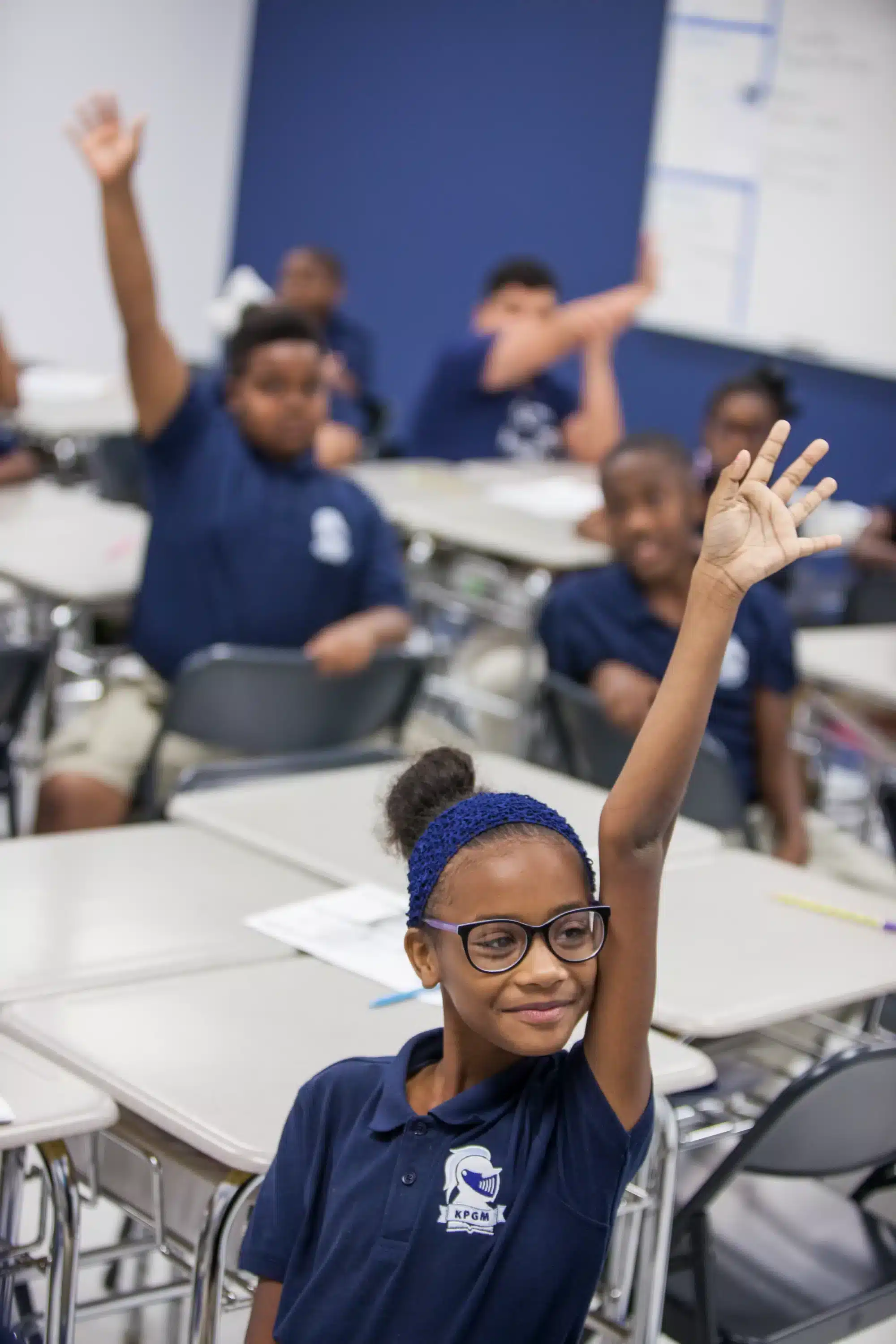 KIPP students raising hands in class