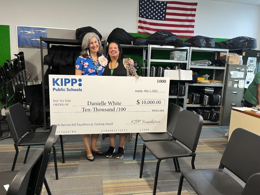 KIPP teachers holding $10,000 check