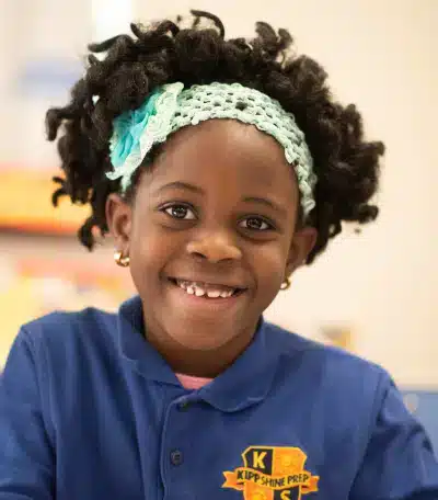 Young girl with curvy hair with KIPP Texas uniform - Primary School