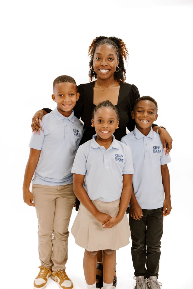 KIPP Texas Teacher Standing with Three Elementary Students