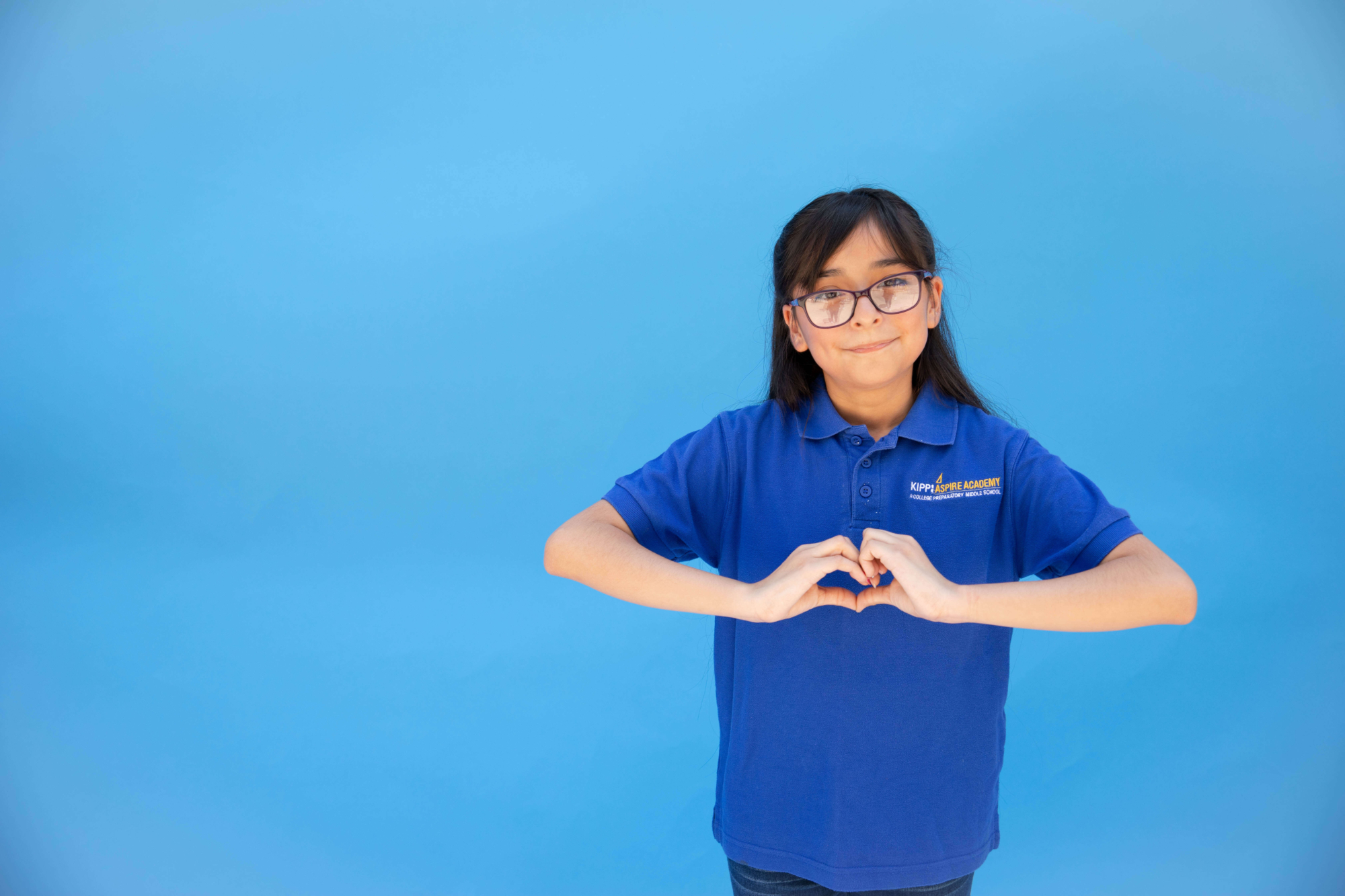 KIPP Texas Middle School Student with Heart Hand Sign