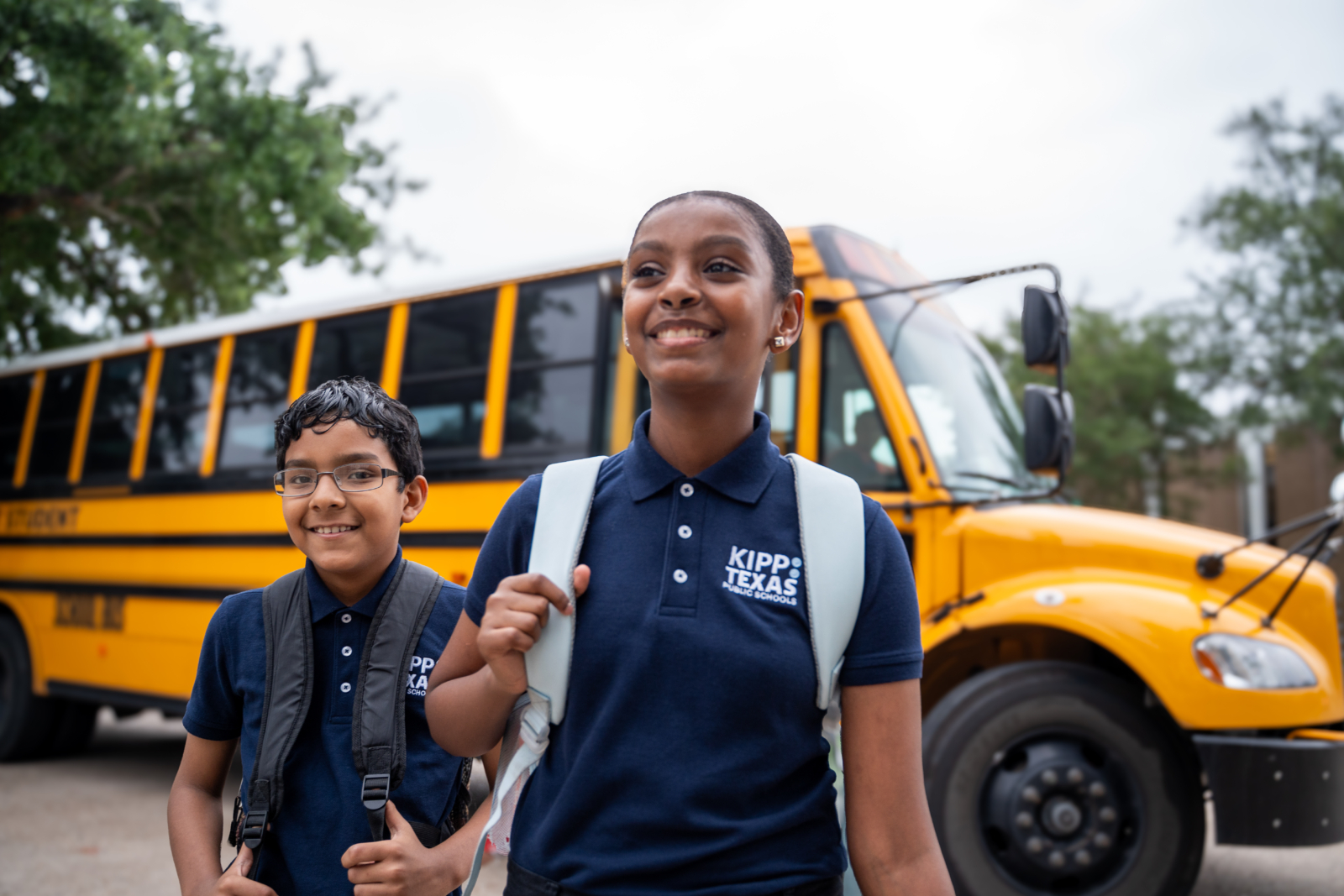 Two Middle School Students With Bus