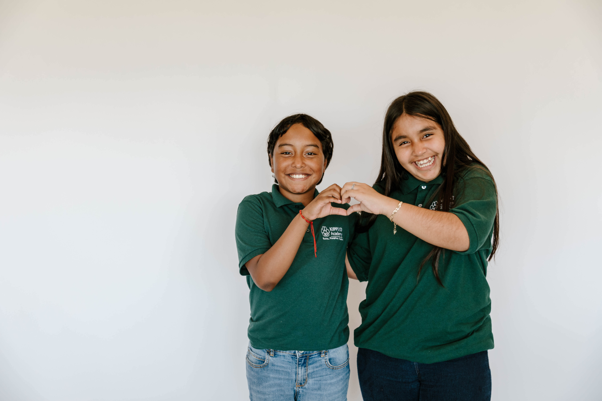 Two KIPP Texas Middle School Students with Heart Hand Sign