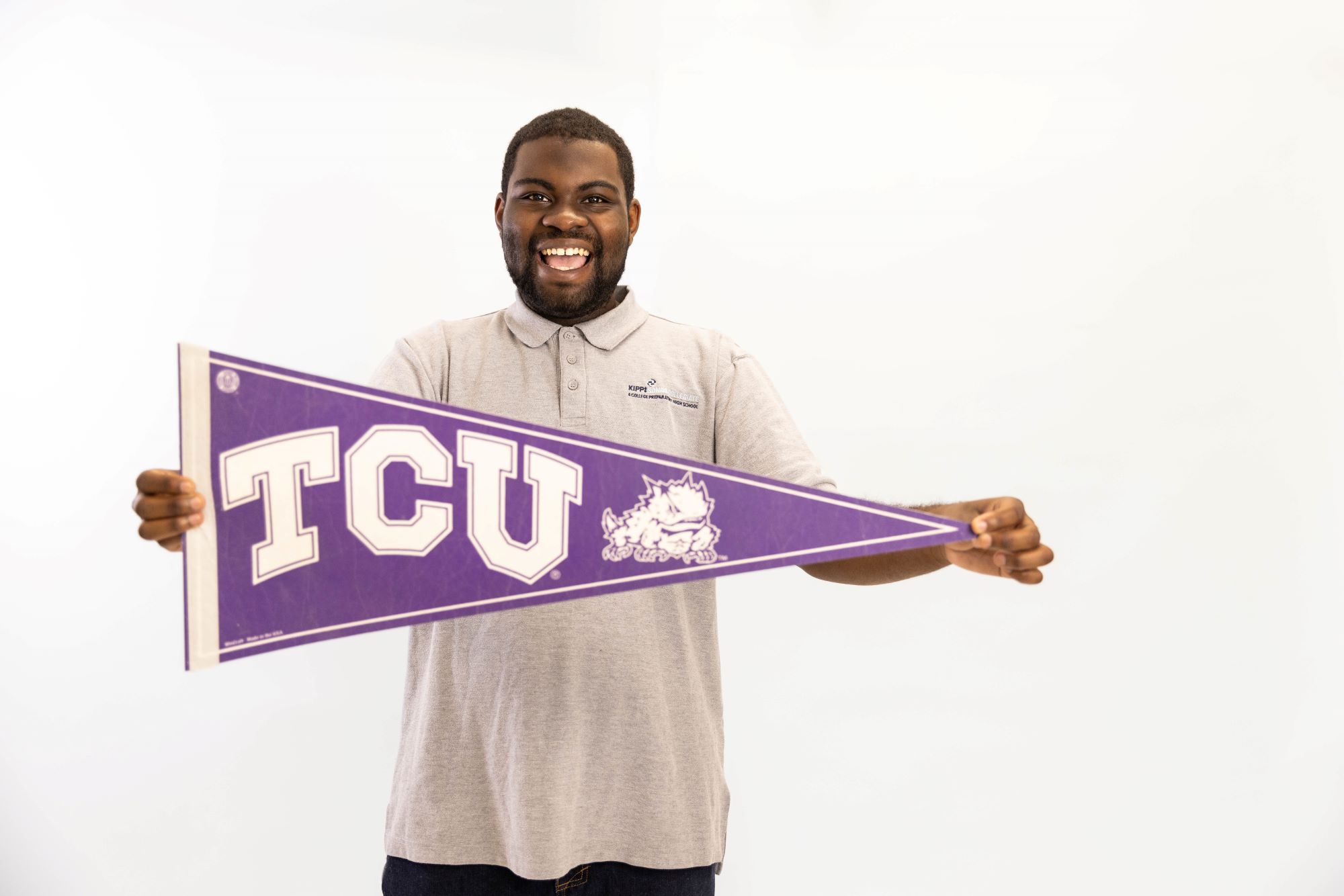 KIPP Texas High School Student Holding a College Banner