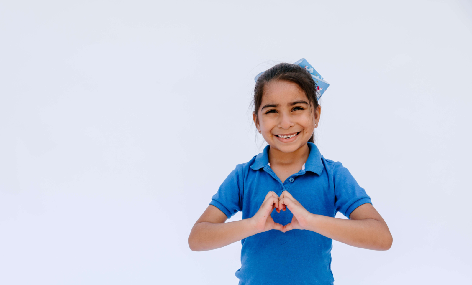 kipp-texas-kindergarten-student-with-heart-shaped-hands