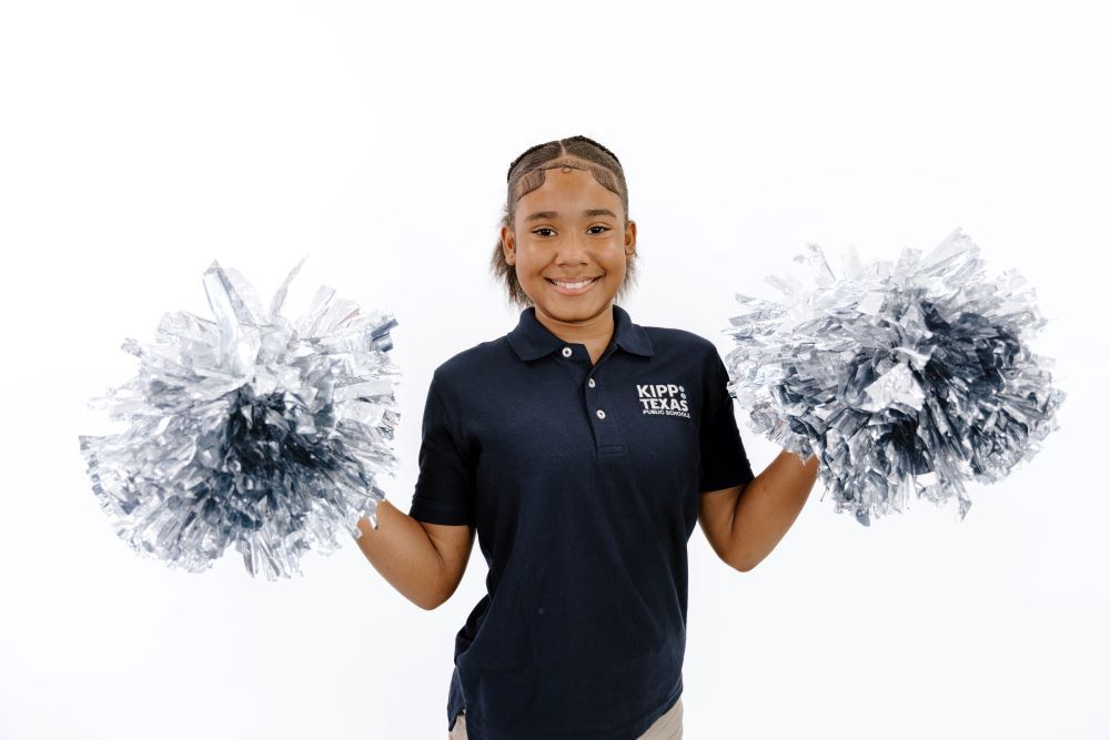 KIPP Texas Middle Student  Holding Pom Poms