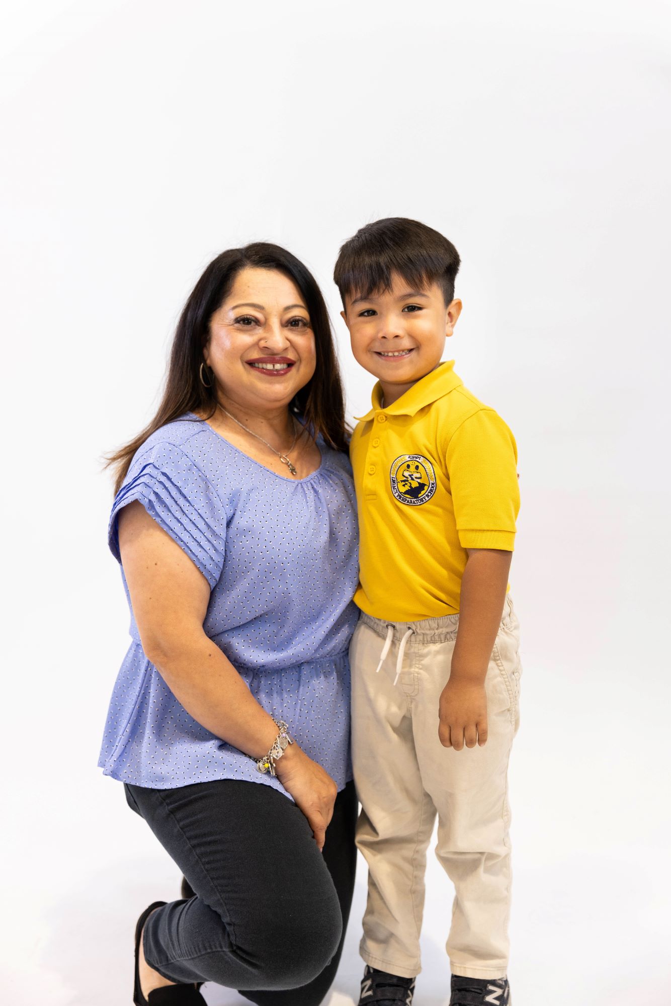 KIPP Texas Teacher Standing Next To An Elementary Student