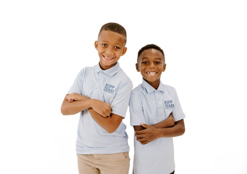 two-elementary-students-crossing-arms