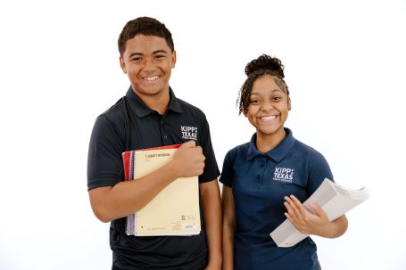 Two Middle School Students Holding Books