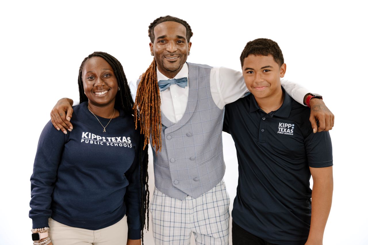 two-middle-school-teachers-with-student-smiling Two Middle School Teachers